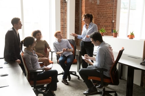 Business people meeting in boardroom at modern office. Diverse group of coworkers discussing project, brainstorming, working on laptop computer. Teamwork concept