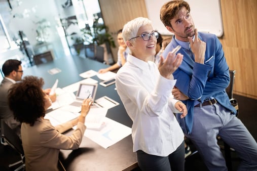 People in a business setting discussing something 