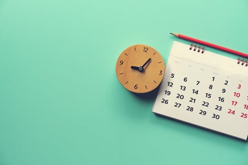 The concept of deadline, with a closeup of a clock and a calendar