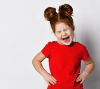 Little girl with hands on her hips and screaming loudly 