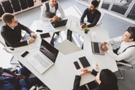 Business people in a meeting using and collaborating with AI tools