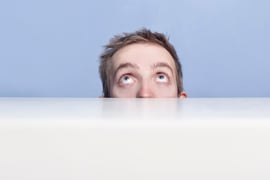 The concept of excuses. A man hiding behind a counter. 