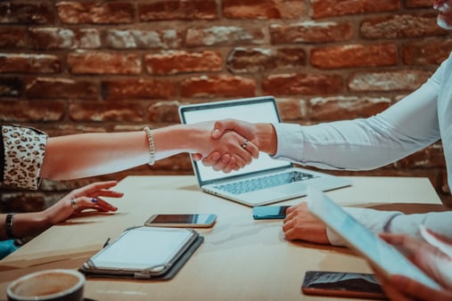 Concept of working together. Two people shaking hands. 