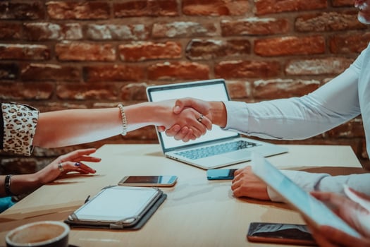Concept of working together. Two people shaking hands. 