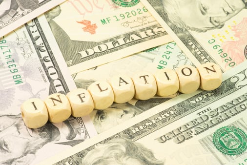 Dollar bills with blocks spelling out the word inflation 
