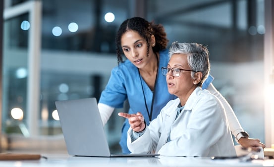 Medical doctor and nurse going over information
