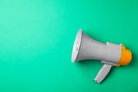 Megaphone on a teal background 