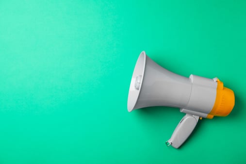 Megaphone on a teal background 