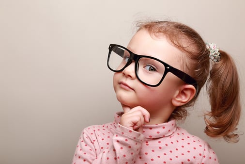 Little girl with pigtails and glasses