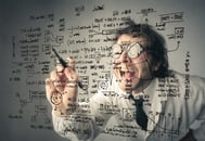 Person with glasses writing complicated formulas on glass