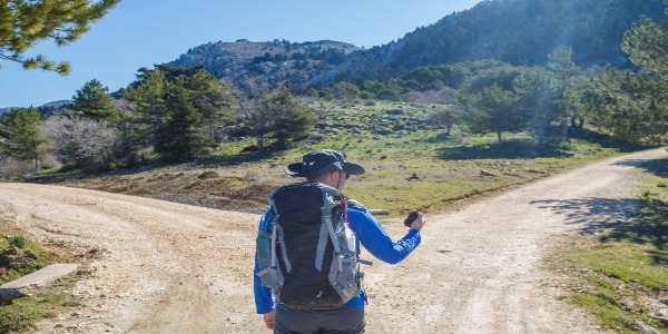 Man on trail deciding between two paths
