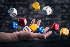 Dice thrown up in the air by a hand