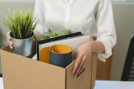 An employee holding the box leaving from the office
