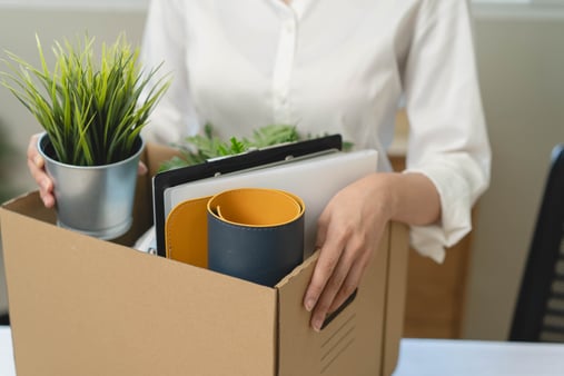 An employee holding the box leaving from the office