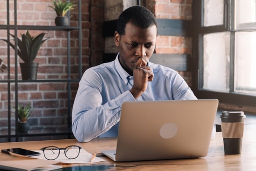 Man sitting at his computer and thinking. Concept of brain trust