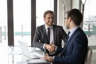 A salesperson and a client doing business with each other