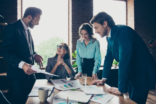 The concept of structure and planning. A team gathering around various business documents. 
