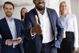 The concept of assertive and confidence. A man holding out his hand to shake. 
