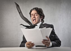 Man looking at a stack of papers