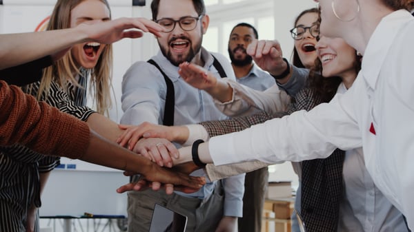 A high-performing team after the success of a project or closing a deal. 