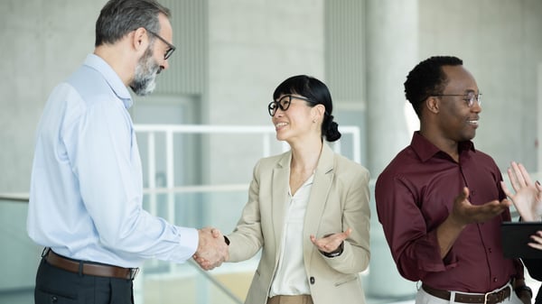 Salespeople shaking hands and trusting each other