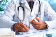 Doctor writing on a piece of paper 