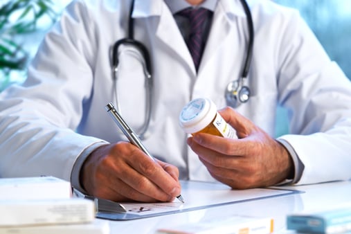 Doctor writing on a piece of paper 