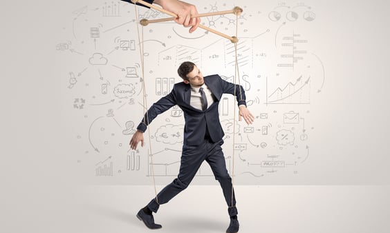 Little businessman controlled from above like a puppet