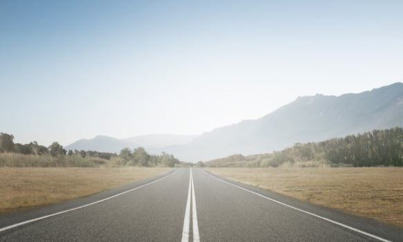 Concept of straight and steady progress over time. A road leading into the distance. 