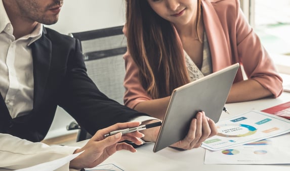 A group of business people sitting at a table and talking 