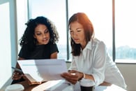 Two businesspeople looking at a plan