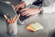 Idea of processing rebates. Someone sitting at a laptop and working. 