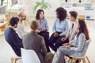 A business team sitting in a circle and working together