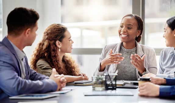 Happy people at the conference table.