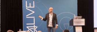 Kevin Trokey speaking to a crowd at Q4Live