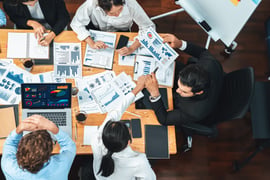 Concept of structured processes. A business team looking at blueprints and charts. 