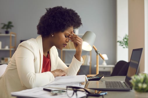 A burned out manager sitting at a computer