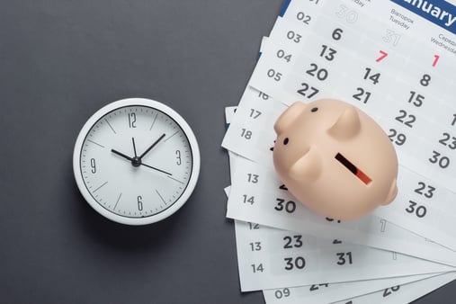 Piggy bank with clock and monthly calendars