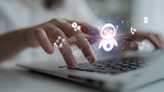Translucent image of AI bots over a keyboard with fingers typing