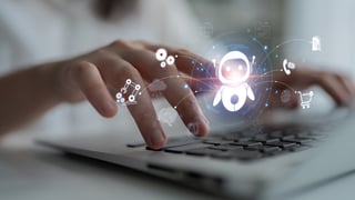 Translucent image of AI bots over a keyboard with fingers typing
