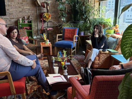 People sitting on coaches having a conversation at Q4Live