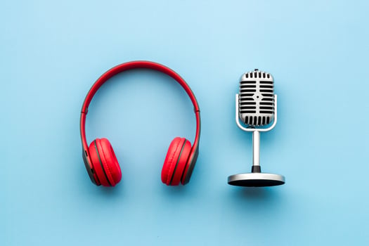 A pair of red headphones and a microphone