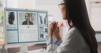 Woman sitting in front of a computer researching medical advice