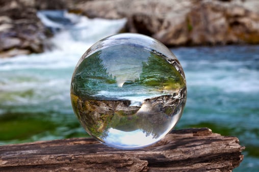 Looking at waterscape through a glass ball