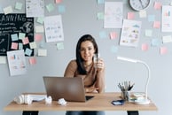A female entrepreneur at her desk, the concept of the myth of doing it all herself 