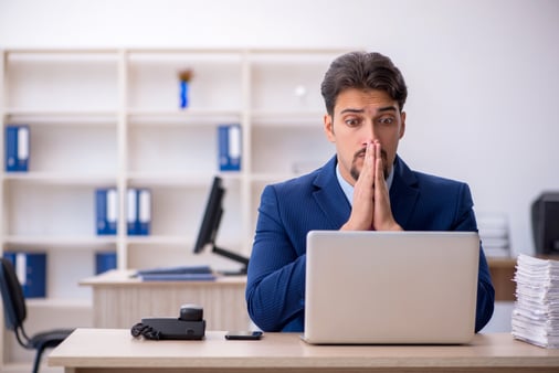 Confused man sitting at computer