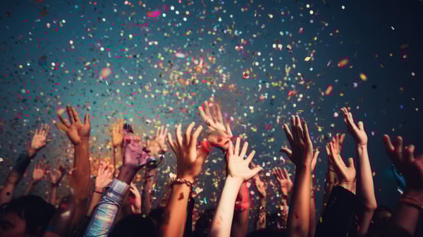 People at a celebration with confetti coming down 