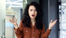 Woman with her hands thrown in the air in frustration