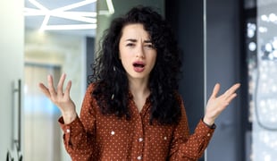 Woman with her hands thrown in the air in frustration