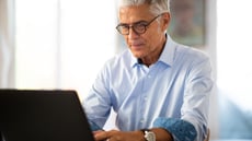 Man typing on his laptop 